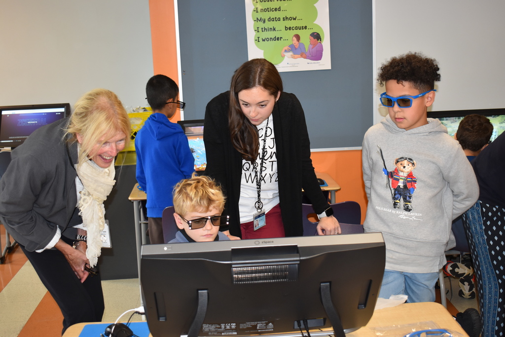 Superintendent Jermain interacting with students on ZSpace computers